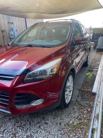 2014 Ford Escape S FWD in red color, parked, with a clean exterior and tan leather interior, low mileage vehicle.