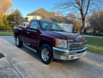 2013 Chevrolet Silverado 1500 in Deep Ruby color, showcasing chrome details and new tires parked in a driveway.