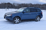 2010 Subaru Forester 2.5X AWD parked in snow, showcasing its all-season capabilities and well-maintained condition.