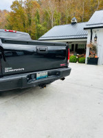 2010 GMC Sierra Denali 1500 rear view, black truck with a solid body and good paint condition