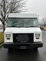 Front view of a 2018 Ford F59 FedEx step van in excellent condition, parked in Portland, Oregon.