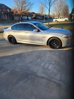2013 BMW 5 Series 535XI AWD xDrive Sedan parked on driveway, showcasing its spotless exterior and stylish black wheels.