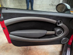 Interior view of a Mini Cooper door with premium sound system and heated seats features