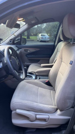 Interior view of a 2019 Honda Pilot showing front seats and dashboard in a clean condition.