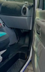 Interior view of a renovated 2001 Ford Econoline 150 camper van with unique decor and storage options.