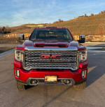 Front view of a red 2020 GMC Denali HD Crew Cab truck with distinctive grille and headlights.