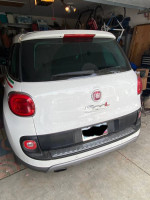 Rear view of a 2014 Fiat 500L Trekking parked in a garage, showcasing the car's design and features.