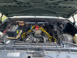 Engine compartment view of a 1984 Chevrolet K5 Blazer with a small block 350 engine and wiring.