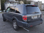 2006 Honda Pilot EX FWD parked, showing sleek exterior and wheels, perfect family SUV in excellent condition.