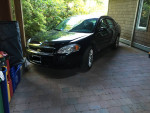 2007 Black Chevrolet Impala SS parked, showcasing sleek design and well-maintained condition.