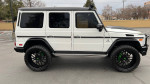 Side view of a modified 2018 Mercedes G 63 AMG with 24-inch wheels and a lifted suspension.