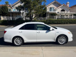 2013 Toyota Camry XLE Hybrid in excellent condition, white color, parked on a street.