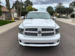 Front view of a 2013 Ram 1500 Sport 4WD truck with clean exterior, parked on a residential street