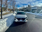 2019 Hyundai Ioniq Electric parked in a snowy neighborhood, showcasing its clean and pristine condition.