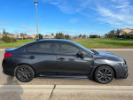 2018 Subaru WRX in grey with black interior parked on a street, showcasing its sleek design and sporty features.