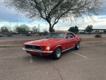 Red 1968 Ford Mustang for sale, showing exterior with minor rust and newer wheels, parked outdoors.