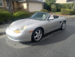 1998 Porsche Boxster convertible with silver exterior parked on a residential street