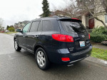 2007 Hyundai Santa Fe Limited in black, parked on a residential street, showcasing its sleek design and good condition.