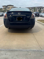 Rear view of a 2007 Nissan Altima 3.5 SE, showcasing sleek design and clean condition in a parking area.