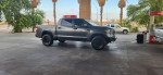 2018 Toyota Tundra TRD Sport 4x4, upgraded with new rims and LED lights, parked at a gas station.