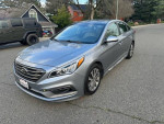 2015 Hyundai Sonata in excellent condition, 130K miles, parked on the street