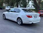 2010 BMW 5 Series 528i Sedan parked, showcasing pristine condition and sleek design.