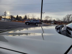 Close-up view of a 2013 Chevrolet Equinox LT AWD parked, showcasing its champagne exterior and surroundings.