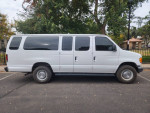 2004 Ford E-350 12 passenger van in excellent condition parked outside