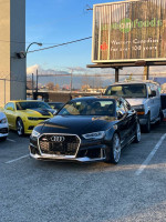 2018 Audi RS3 in Panther Black with B&O sound system, parked in a lot among other cars