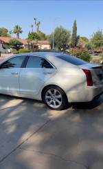 2013 Cadillac ATS Performance RWD in white, showcasing sleek design and new tires.