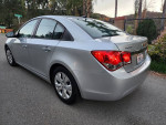 2014 Chevrolet Cruze LS in silver with black cloth interior, parked on the street.