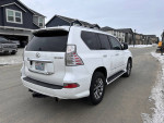 2015 Lexus GX 460 4WD parked in a residential area, featuring a white exterior and modern design.