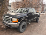 1999 Ford F350 Super Duty manual transmission truck parked, ideal for projects and farm use, showing robust design.