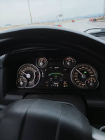 Dashboard view of a 2014 Ram 1500 showing mileage and various controls, perfect for truck enthusiasts.