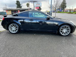 2005 Infiniti G35 Coupe in black with aftermarket rims, showcasing a clean exterior and smooth design.