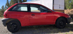 1998 Chevrolet Metro red hatchback with 100,000 miles parked outdoors