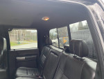 Interior of a 2014 Ford F350 Super Duty showing black leather seats and spacious cabin