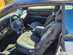 Interior of a 2006 Chrysler Sebring Convertible with black seats and steering wheel.