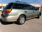 2004 Subaru Outback AWD wagon parked outdoors, showcasing its exterior and alloy wheels.
