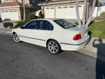2000 BMW 540i in Alpine white with beige leather interior parked in a residential area