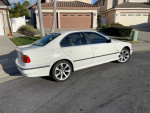 2000 BMW 540i in Alpine white, showcasing its clean exterior and stylish design on a residential street.
