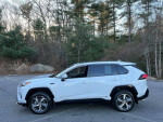 2022 Toyota RAV4 Prime SE in immaculate condition parked in a natural setting, side view, for sale.