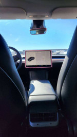 Interior view of a 2023 Tesla Model Y with a large touchscreen and heated seats