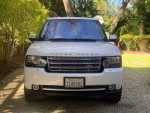 Front view of a 2012 Land Rover Range Rover Supercharged, white exterior, parked in a residential area.