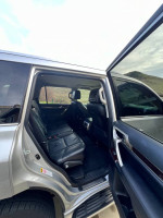 Interior view of a silver 1015 Lexus GX 460 Luxury Edition with black leather seats.