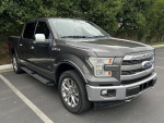 2017 Ford F-150 Lariat 4WD in excellent condition parked, showcasing its sleek design and chrome accents.