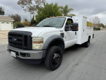 2009 Ford F450 utility truck with low miles, clean title, parked on the street.