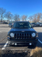 Front view of a 2012 Jeep Patriot in excellent condition parked in a lot
