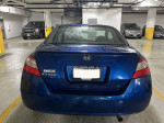 Blue 2010 Honda Civic EX parked indoors with clean title and 66,000 miles, well-maintained with no accidents.