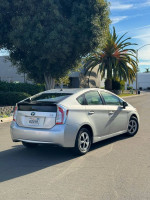 2015 Toyota Prius II in silver parked on street, showcasing hybrid design and excellent condition.